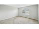 Bright bedroom with neutral walls, plush carpeting and a window offering a view at 440 Langham Dr, Davenport, FL 33897