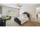 Cozy bedroom with plush carpet, ceiling fan, and large window providing ample natural light at 440 Langham Dr, Davenport, FL 33897