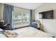 Inviting bedroom with a TV, a large window with curtains, and classic furniture at 440 Langham Dr, Davenport, FL 33897