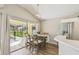 Bright dining area with sliding glass doors leading to a screened-in pool at 440 Langham Dr, Davenport, FL 33897