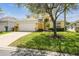 Charming two-story home with a lush lawn and a spacious driveway leading to a two-car garage at 440 Langham Dr, Davenport, FL 33897