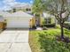 Charming two-story home featuring a manicured lawn, driveway, and attached two-car garage at 440 Langham Dr, Davenport, FL 33897