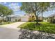 Charming two-story home with a lush lawn and a spacious driveway leading to a two-car garage at 440 Langham Dr, Davenport, FL 33897