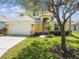 Two-story home boasts well-kept landscaping, attached two-car garage and inviting front entrance at 440 Langham Dr, Davenport, FL 33897