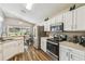 Modern kitchen with stainless steel appliances and adjacent dining area at 440 Langham Dr, Davenport, FL 33897