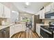 Well-lit kitchen featuring stainless steel appliances and white cabinetry at 440 Langham Dr, Davenport, FL 33897