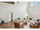 Well-lit living room boasts soaring ceilings, wood floors, and a comfortable seating area at 440 Langham Dr, Davenport, FL 33897