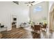 Bright living room featuring high ceilings, wood floors, and neutral colored furnishings at 440 Langham Dr, Davenport, FL 33897