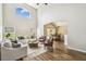 Comfortable living room with a large window, high ceilings, and neutral-toned furniture at 440 Langham Dr, Davenport, FL 33897