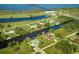 Scenic aerial view of waterfront homes, canals, and a pier extending into the ocean at 6589 Banyan Dr, Indian Lake Estates, FL 33855