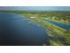 Breathtaking aerial view of the expansive lake, showcasing the vibrant green shoreline at 6589 Banyan Dr, Indian Lake Estates, FL 33855