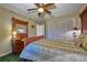 Bedroom featuring a large bed, wood furnishings, and closet with louvered doors at 6589 Banyan Dr, Indian Lake Estates, FL 33855