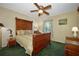 This bedroom features a ceiling fan and a large wooden bed frame at 6589 Banyan Dr, Indian Lake Estates, FL 33855