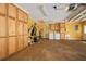 Spacious garage with storage cabinets, laundry area, and workout equipment at 6589 Banyan Dr, Indian Lake Estates, FL 33855