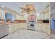 Spacious kitchen featuring ample cabinetry, stainless steel appliances, and a unique ceiling fan at 6589 Banyan Dr, Indian Lake Estates, FL 33855