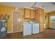 Laundry area with washer, dryer, and utility sink in the garage at 6589 Banyan Dr, Indian Lake Estates, FL 33855