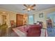 Cozy living room with stylish decor, comfortable seating, and a decorative ceiling fan at 6589 Banyan Dr, Indian Lake Estates, FL 33855