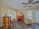 Bright room features a charming desk, unique bar with stools and decorative chair on marble tile floor at 6589 Banyan Dr, Indian Lake Estates, FL 33855