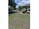 Spacious yard with grassy areas, a chain-link fence, and some debris needing removal for a clean and inviting look at 1211 Ne 4Th St, Mulberry, FL 33860