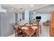 Open dining area with a wooden table, stainless steel fridge, leading into the living room at 820 Lamp Post Ln, Lakeland, FL 33809