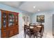 Dining area featuring a wooden table, china cabinet, and doors leading to the outdoor area at 820 Lamp Post Ln, Lakeland, FL 33809