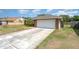 Brick home featuring a white garage door and a wide driveway at 820 Lamp Post Ln, Lakeland, FL 33809