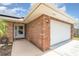 Brick exterior of the home showing the front door and garage at 820 Lamp Post Ln, Lakeland, FL 33809