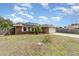 Lovely brick home with solar panels and a well-manicured front yard at 820 Lamp Post Ln, Lakeland, FL 33809