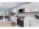 Modern kitchen featuring stainless steel appliances and white cabinets with gold handles at 820 Lamp Post Ln, Lakeland, FL 33809