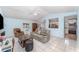 Comfortable living room with tile floors, a ceiling fan, and access to the kitchen at 820 Lamp Post Ln, Lakeland, FL 33809