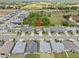 Drone shot showing the house location in a suburban neighborhood near a field at 5008 Ne 125Th Loop, Oxford, FL 34484