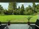 Serene backyard with a lush green lawn and trees creating a tranquil outdoor space at 5008 Ne 125Th Loop, Oxford, FL 34484