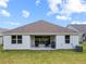 Backyard patio featuring outdoor seating, grill, and sliding glass door for easy indoor/outdoor living at 5008 Ne 125Th Loop, Oxford, FL 34484