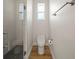 Modern bathroom featuring a sleek, glass-enclosed shower with dark herringbone tile flooring at 5008 Ne 125Th Loop, Oxford, FL 34484