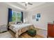 Bedroom with hardwood floors, natural light, and a serene atmosphere, creating a cozy and inviting space at 5008 Ne 125Th Loop, Oxford, FL 34484