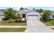 Charming single-story home with a well-maintained lawn, an attractive front door, and an attached two-car garage at 5008 Ne 125Th Loop, Oxford, FL 34484