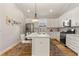 A well-appointed kitchen features ample countertop space, white cabinetry, stainless appliances, and a functional island at 5008 Ne 125Th Loop, Oxford, FL 34484