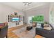 A bright and airy living room with entertainment center and sliding glass doors to the outdoor patio at 5008 Ne 125Th Loop, Oxford, FL 34484