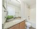 Bathroom with granite counters, wood cabinets, and tub shower combination at 1628 Saddlehorn Dr, Lakeland, FL 33810