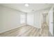 Bright bedroom with light wood floors, large closet, and natural light from the window at 1628 Saddlehorn Dr, Lakeland, FL 33810