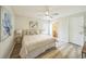 Bright bedroom with modern ceiling fan, wood floor and a decorative painting on the wall at 1628 Saddlehorn Dr, Lakeland, FL 33810