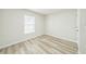 Cozy bedroom featuring wood-look floors and a window for natural light at 1628 Saddlehorn Dr, Lakeland, FL 33810
