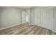 Bedroom features wood-look floors, neutral walls, and a closet with bifold doors at 1628 Saddlehorn Dr, Lakeland, FL 33810