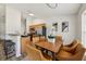 Bright dining area features a wooden table, six chairs, and is adjacent to the kitchen with modern stainless steel appliances at 1628 Saddlehorn Dr, Lakeland, FL 33810