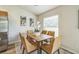 Modern dining area featuring a wood table with six chairs and natural light at 1628 Saddlehorn Dr, Lakeland, FL 33810