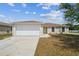 Charming single-story home featuring a two-car garage and well-maintained lawn at 1628 Saddlehorn Dr, Lakeland, FL 33810