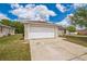 Well-maintained single-story home with a two-car garage and long concrete driveway at 1628 Saddlehorn Dr, Lakeland, FL 33810