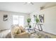 Bright living room featuring modern decor, wood floors, and natural light from a sliding glass door at 1628 Saddlehorn Dr, Lakeland, FL 33810