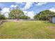 Large, fenced backyard with lush green grass and trees, perfect for pets and outdoor enjoyment at 4844 Creek Meadow Trl, Lakeland, FL 33810