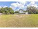 Expansive backyard with mature trees, offering ample space for outdoor activities and relaxation at 4844 Creek Meadow Trl, Lakeland, FL 33810